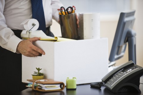 A businessman packing up desk