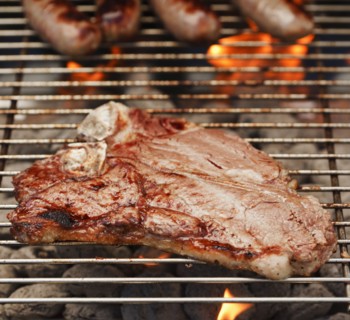 Steak and sausages on a barbeque