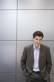 A businessman by a wall.
