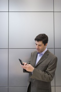 A businessman using a cellular phone.