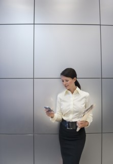 A businesswoman using a personal digital assistant.
