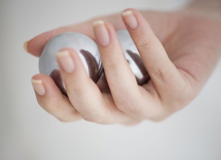 Hand holding Chinese balls.