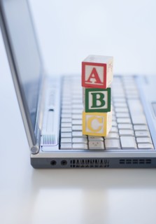 Letter blocks on laptop.