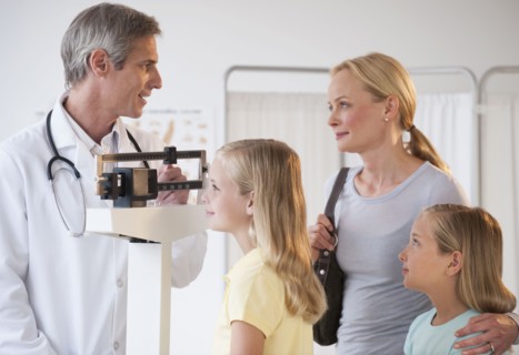 Mother and daughters at Doctor's office.