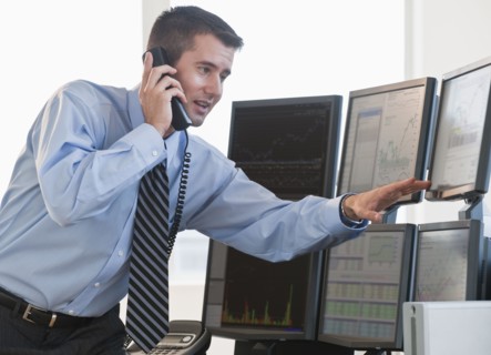 Trader studying computer screens.