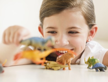 Child playing with dinosaurs
