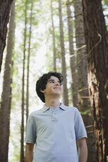 Smiling boy behind tree