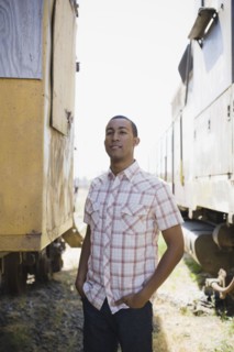 Young man beside train