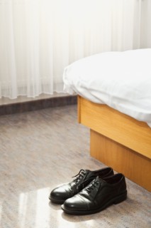Shoes in front of bed