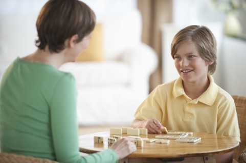 Mother playing game with child.