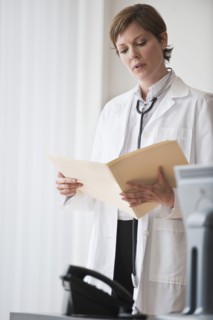 Female doctor reviewing notes.
