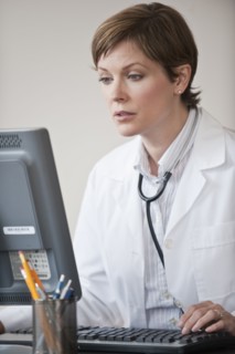 Female doctor working on laptop.