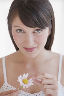 Woman plucking daisy.