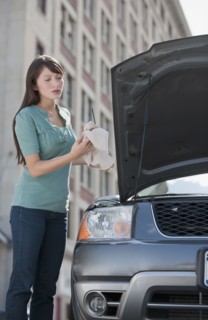 Woman checking oil.
