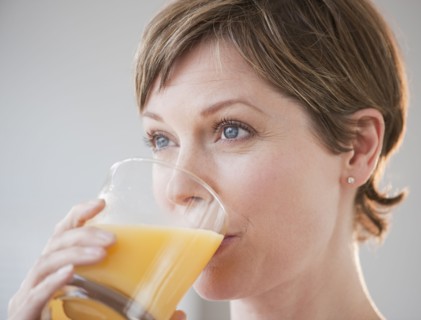 Woman drinking orange juice.