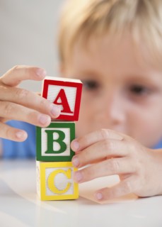 Child playing with ABC blocks.