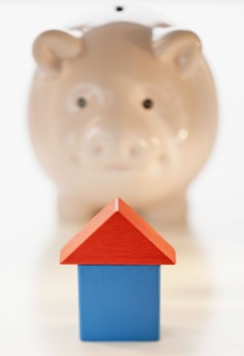 Piggy bank and symbolic house.