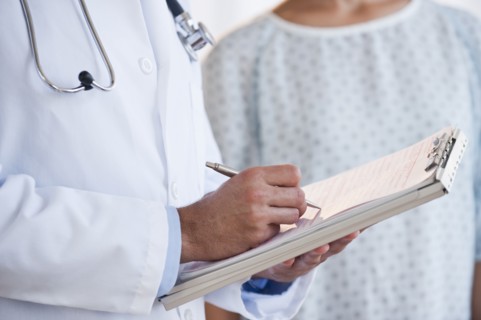 Doctor studying patient chart.