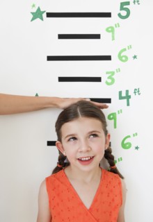 Child having height measured