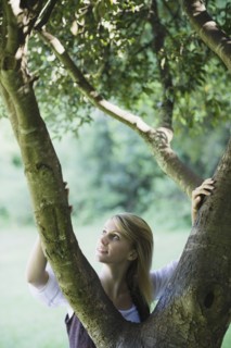 Smiling woman behind tree