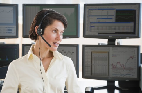 Female trader on headset.