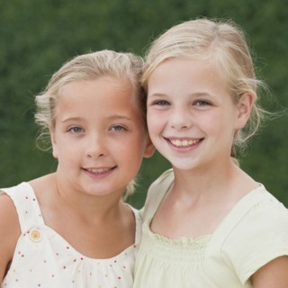 Young sisters smiling.