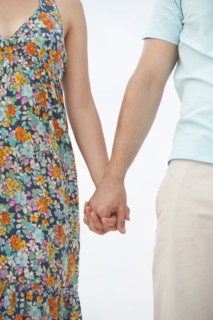 Couple holding hands.