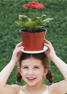 Child with plant on head