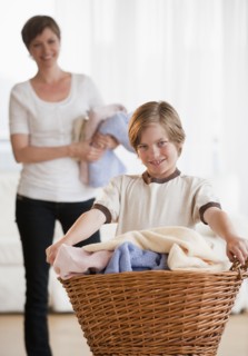 Mother and child doing laundry.