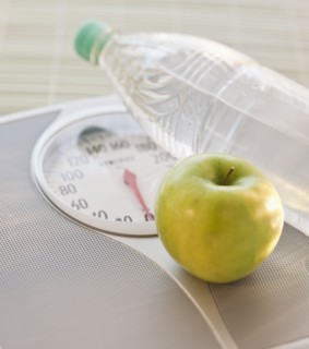 Scale apple and water bottle.