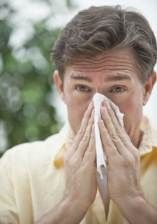 Man blowing nose.