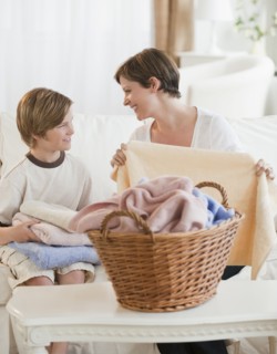 Mother and child folding laundry.