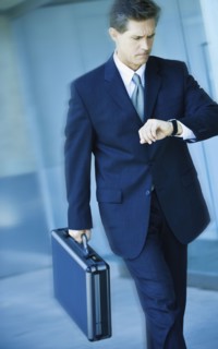 Businessman looking at watch.