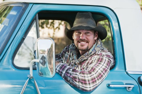 Cowboy driving truck.