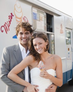 Bride and groom eating ice cream