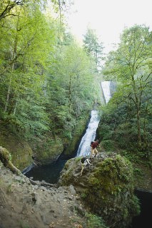 Hikers in front of waterfall