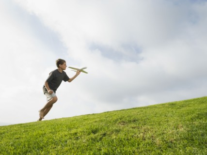 Boy playing with toy airplane
