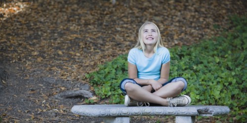 Young girl sitting on bench