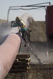 Construction worker cleaning pipleline