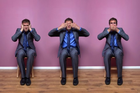 Three businessmen sitting in chairs