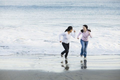 Girls running on beach