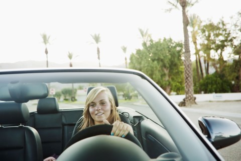 Woman driving convertible