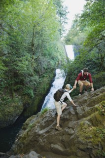 Hikers in front of waterfall