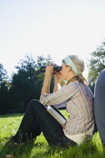 Woman looking through binoculars