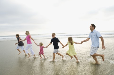 Family holding hands in ocean