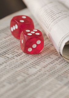 Two dice on newspaper