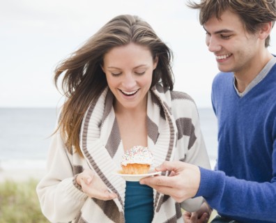 Man giving woman cupcake