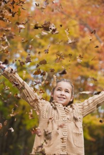 Girl throwing leaves.