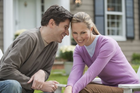 Couple in front of house.
