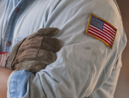 Blue collar working wearing American flag patch.